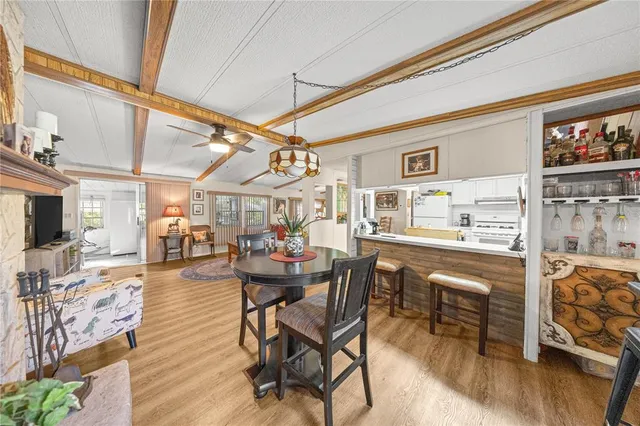 a dining room with furniture and wooden floor