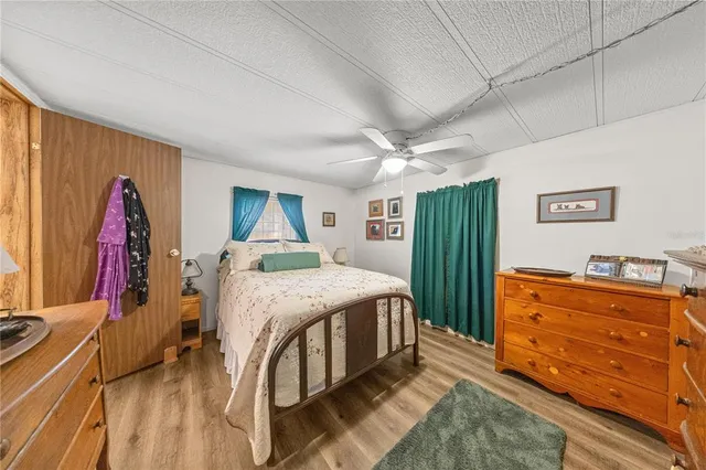 a spacious bedroom with a bed and a dresser