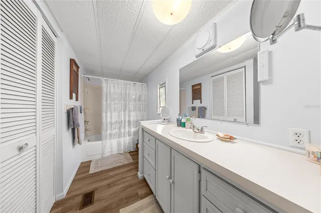 a spacious bathroom with a double vanity sink and mirror