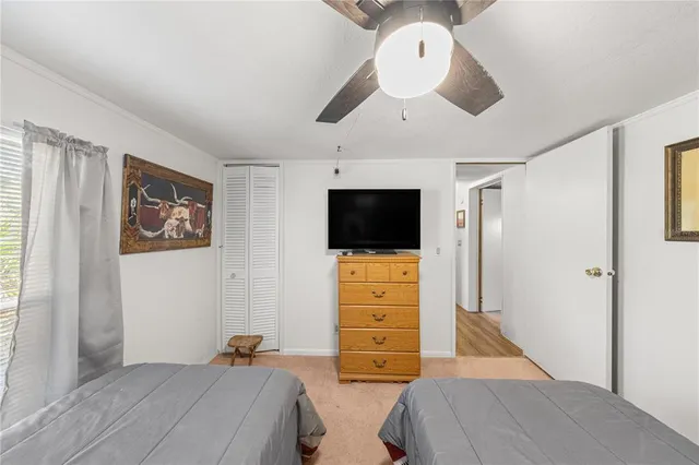 a bedroom with bed and flat screen tv