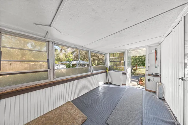 a view of an empty room with large windows