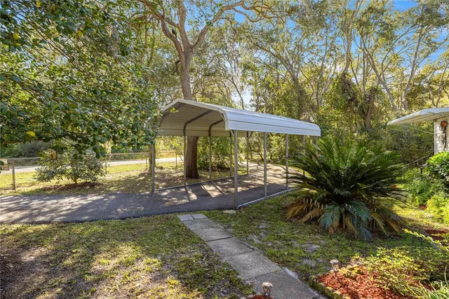 a view of a garden with a table and chairs under an umbrella