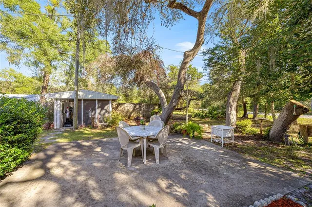 a view of a patio with table and chairs and potted plants