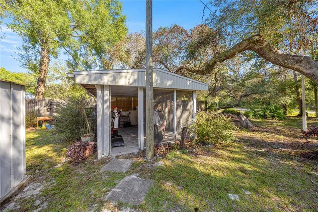 a view of a house with a tree in front of it