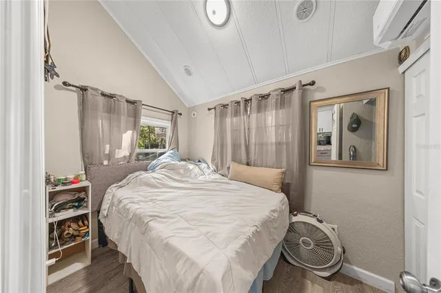 a bedroom with a bed a mirror and a window