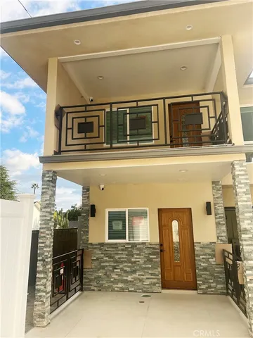 a front view of a house with many windows