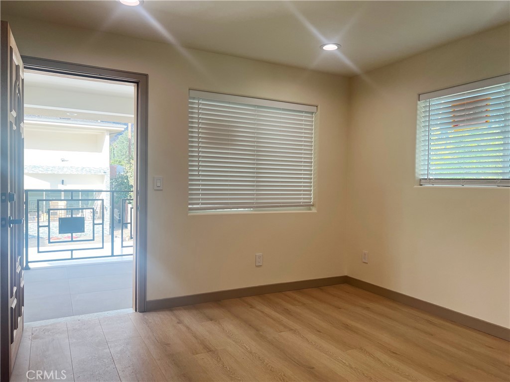 1514 East Woodbury Road, Unit 1/2 Pasadena, CA 91104 - Photo 8 of 14 a view of an empty room with wooden floor and a window