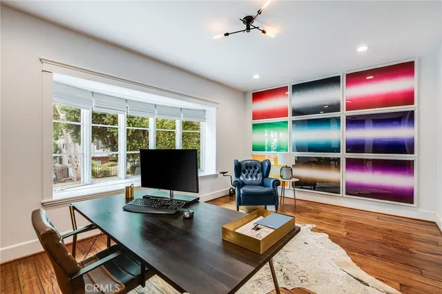 a living room with furniture gaming tables and a flat screen tv