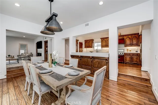 a view of a dining room with furniture wooden floor and chandelier