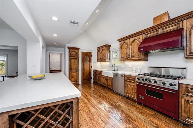 a kitchen with stainless steel appliances granite countertop a stove and a refrigerator