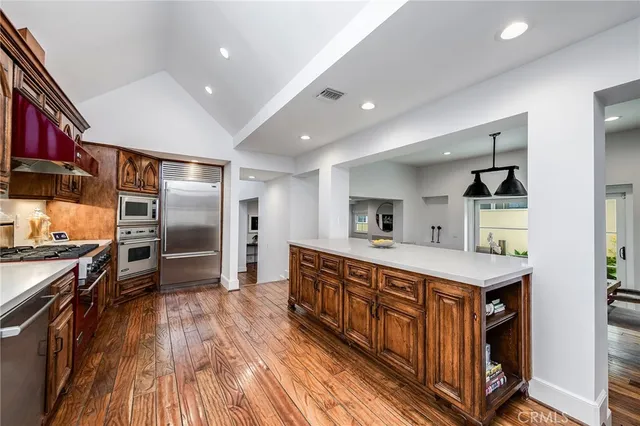 a kitchen with stainless steel appliances granite countertop a stove and a refrigerator