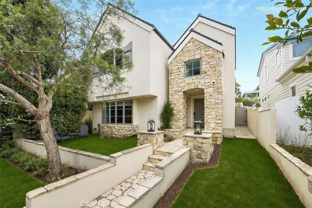 a front view of a house with garden and porch
