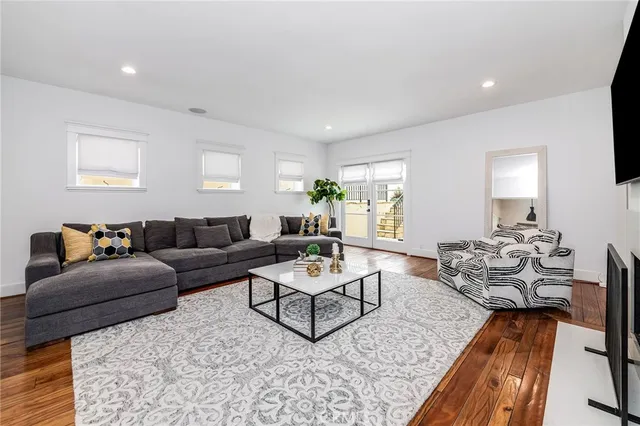a living room with furniture a fireplace and a rug