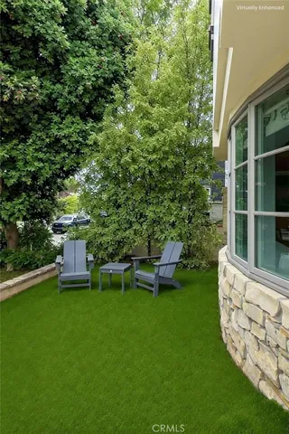 a view of a porch with furniture and floor to ceiling window