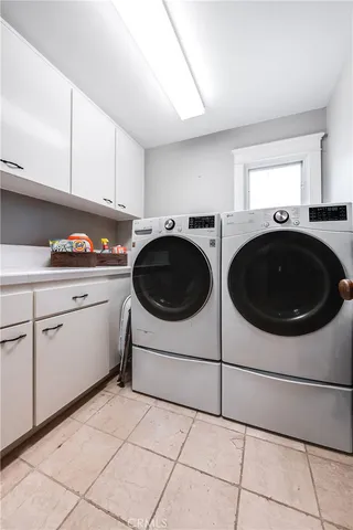 a view of a hallway with a livingroom and a bathroom with sink