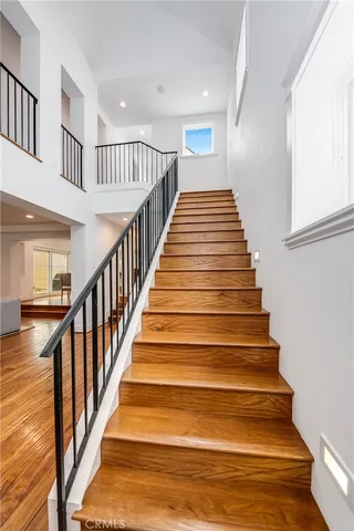 a bedroom with a bed and a flat tv screen on dresser