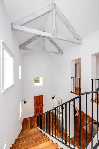a view of a room with wooden floor and furniture