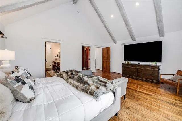 a bedroom with a large bed and a window