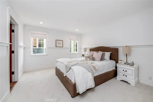 a bedroom with two beds and a window