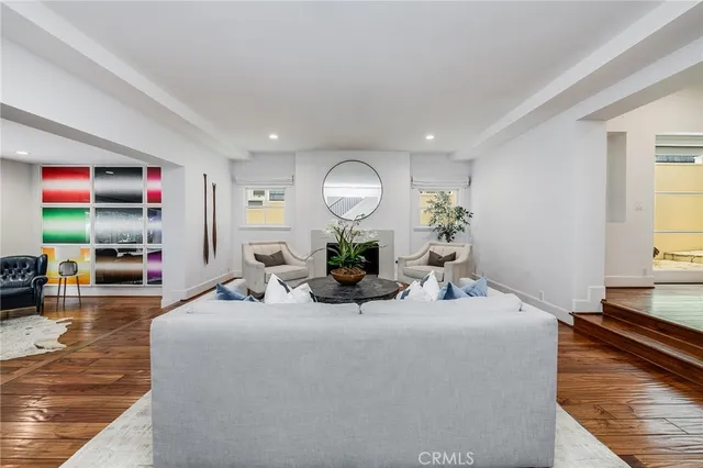 a living room with fireplace furniture and a large window
