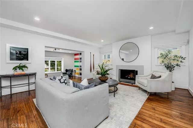 a living room with furniture a fireplace and a potted plant