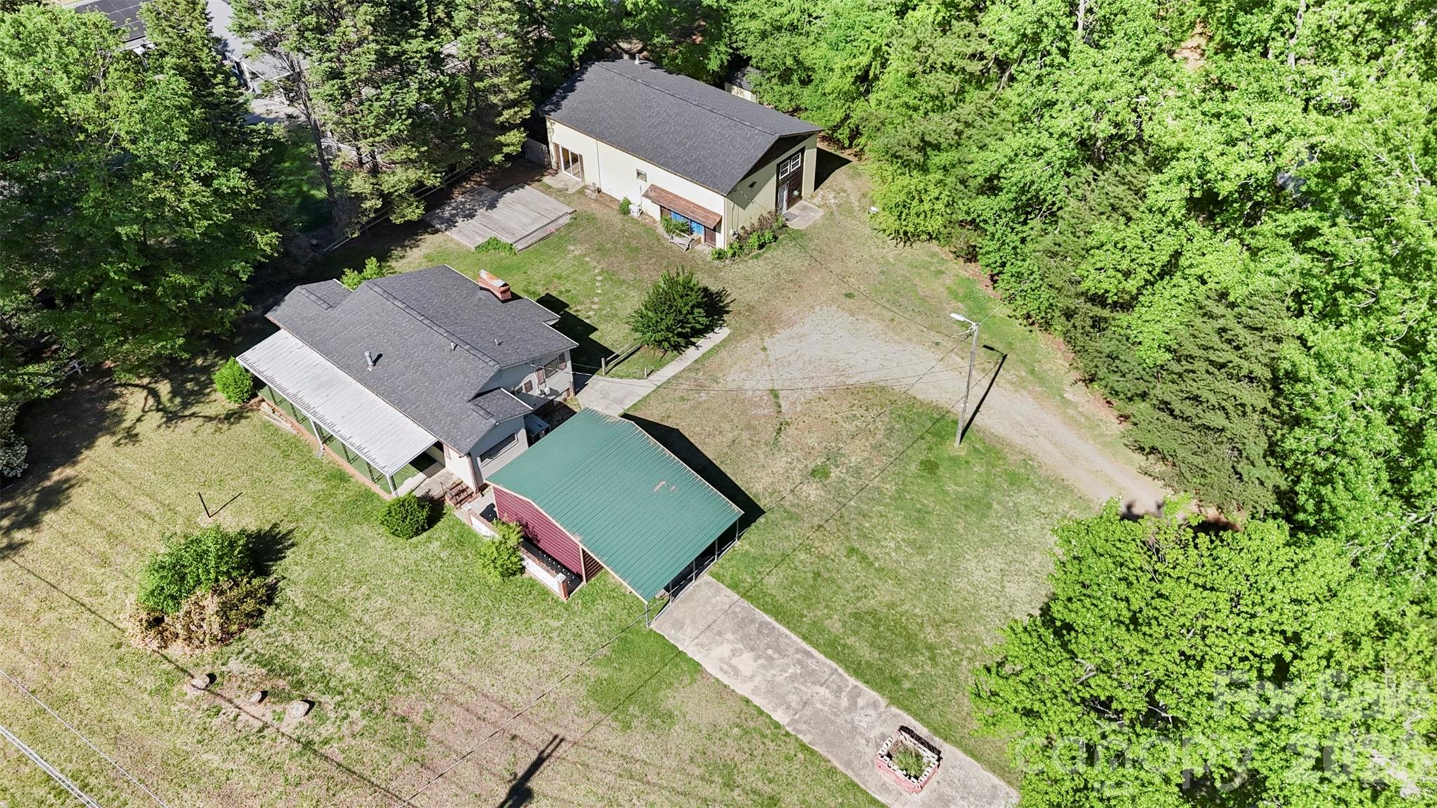 an aerial view of residential house with outdoor space and swimming pool