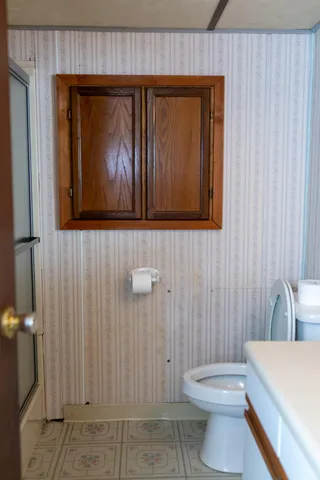 a view of an empty room with a fireplace and a window