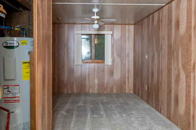 a kitchen with a sink a refrigerator and wooden floor