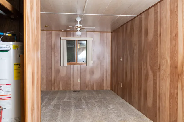 a kitchen with a stove a sink and a refrigerator with wooden floor