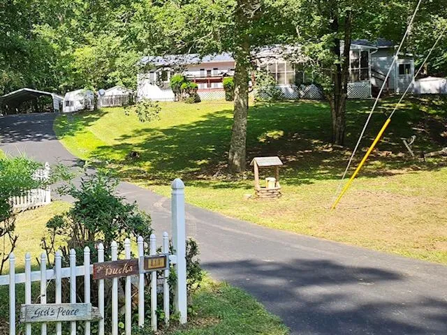 a view of a swimming pool with a patio and a yard