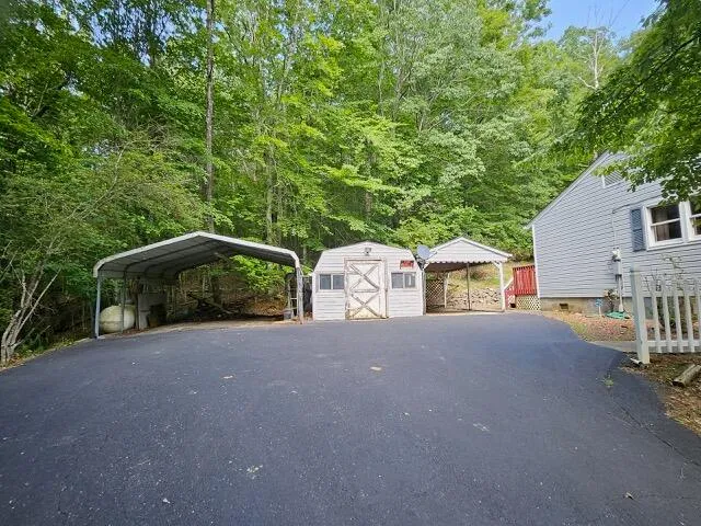 a backyard of a house with a swing table and chairs