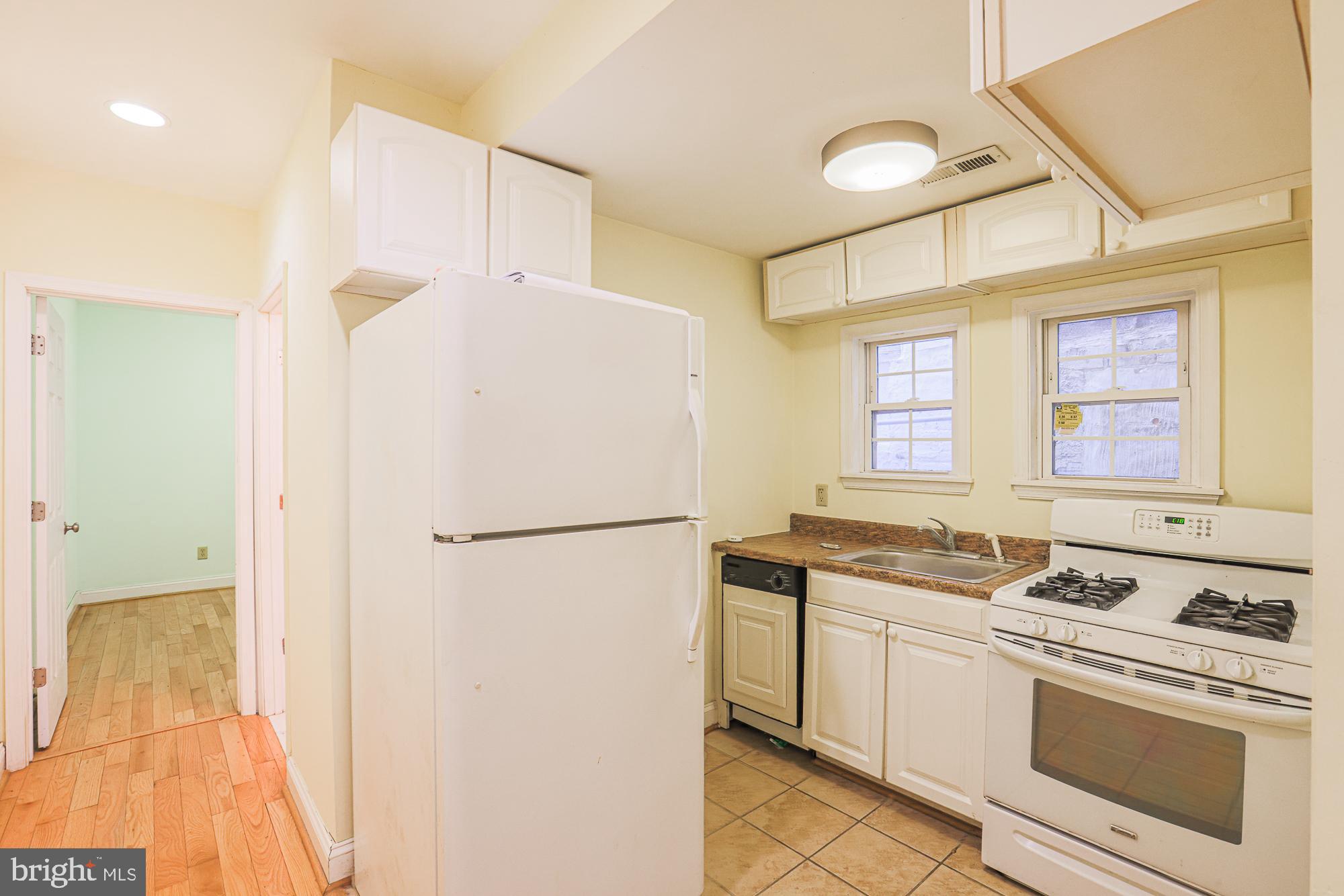 1447 William Street Baltimore, MD 21230 - Photo 31 of 72 a white refrigerator freezer sitting inside of a kitchen