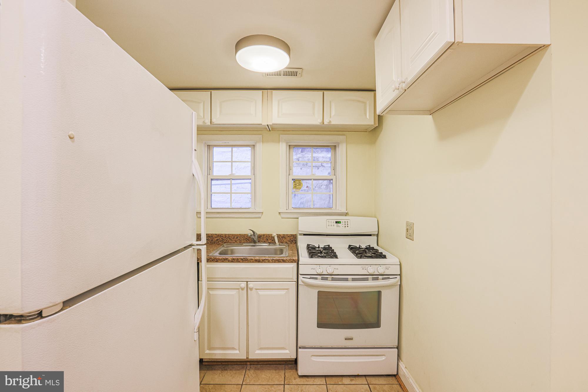 1447 William Street Baltimore, MD 21230 - Photo 32 of 72 a kitchen with a stove and a microwave