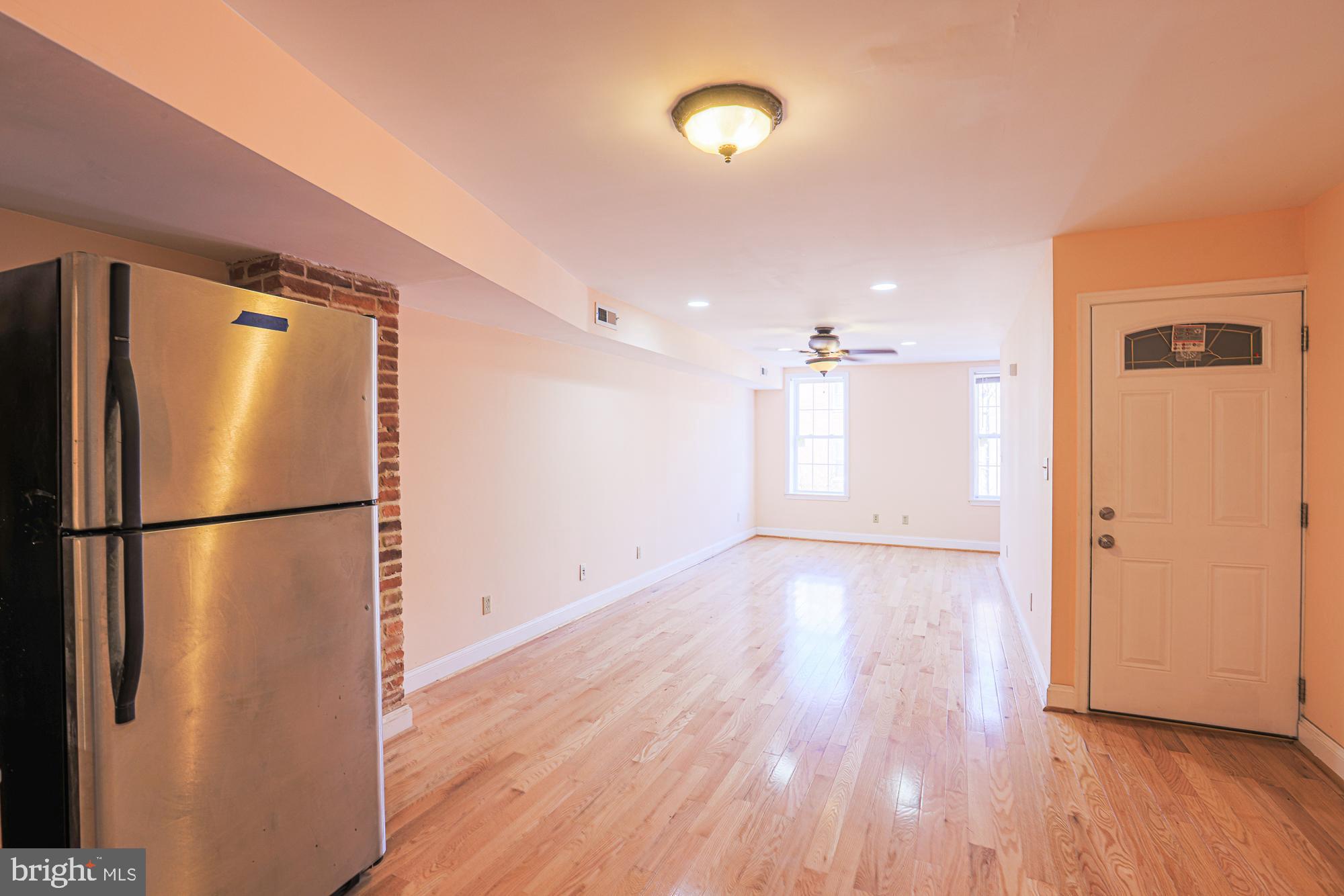1447 William Street Baltimore, MD 21230 - Photo 40 of 72 a view of a kitchen with a refrigerator and a stove top oven