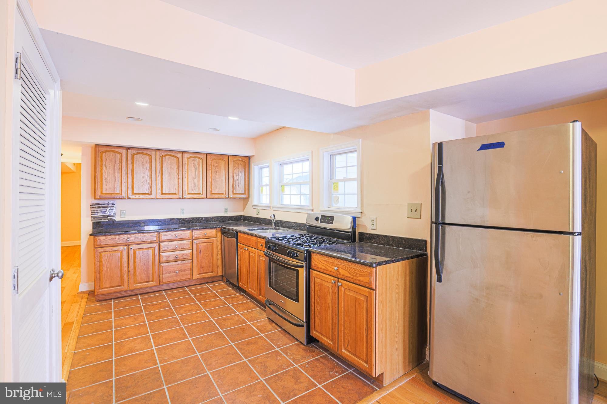 1447 William Street Baltimore, MD 21230 - Photo 42 of 72 a kitchen with granite countertop stainless steel appliances a refrigerator a sink and a counter top space