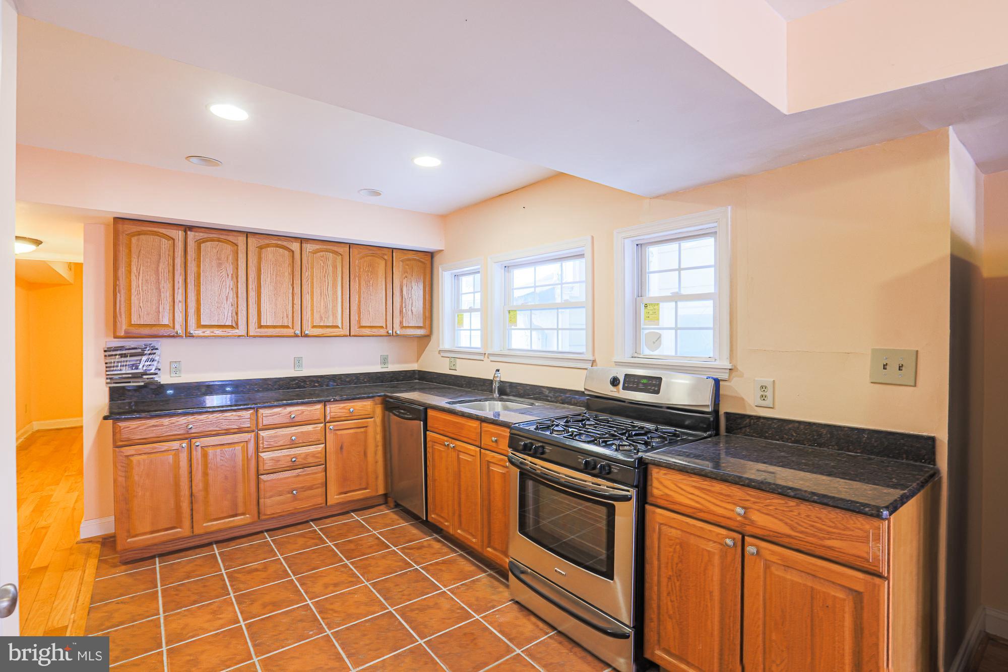 1447 William Street Baltimore, MD 21230 - Photo 43 of 72 a kitchen with stainless steel appliances granite countertop a sink stove and cabinets