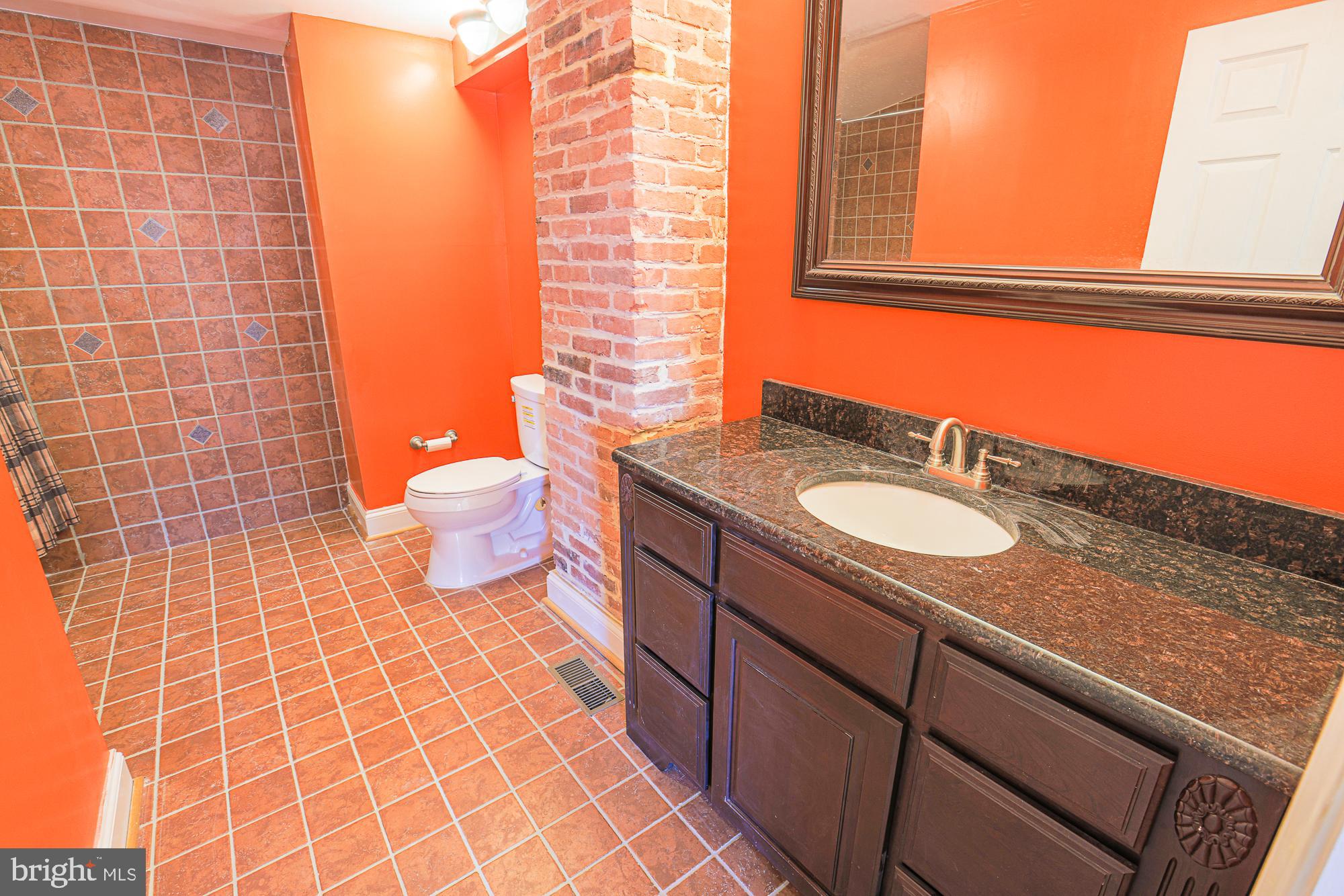 1447 William Street Baltimore, MD 21230 - Photo 60 of 72 a bathroom with a sink and a toilet