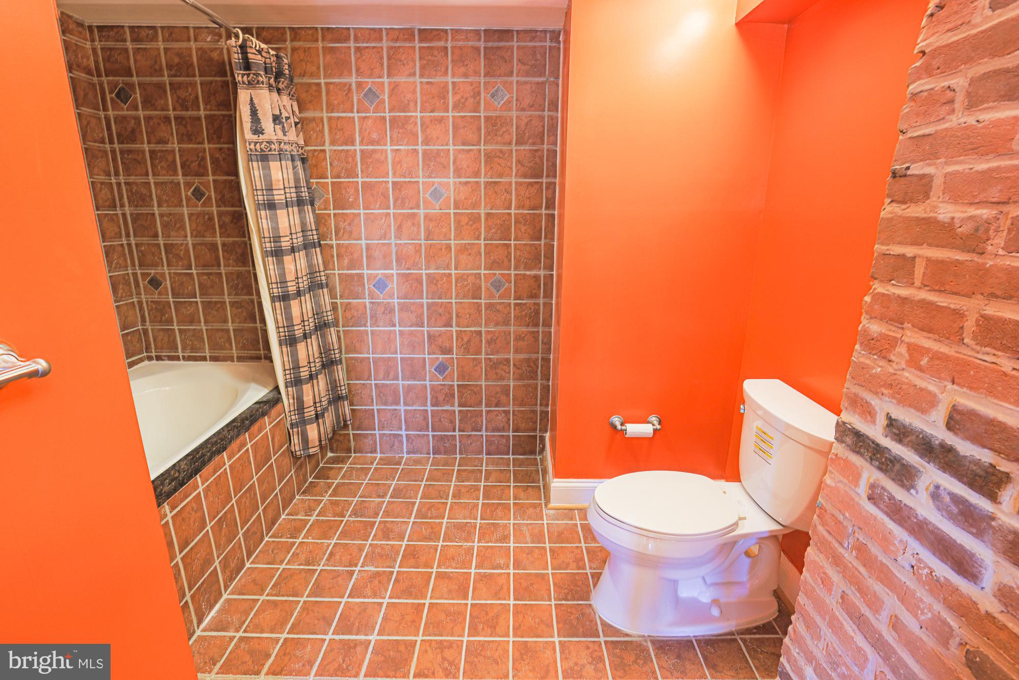 1447 William Street Baltimore, MD 21230 - Photo 61 of 72 a bathroom with a blue toilet and a shower