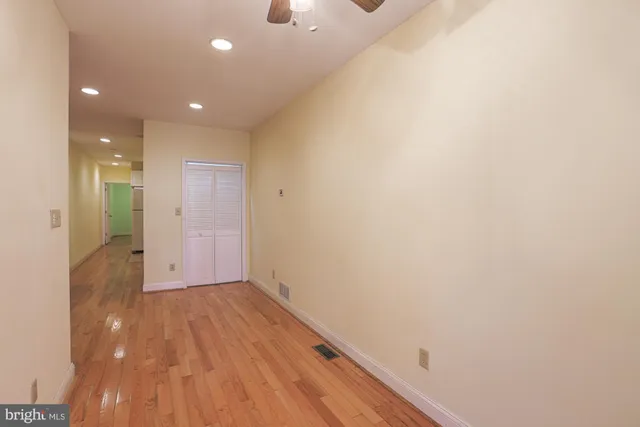 a view of a hallway with wooden floor