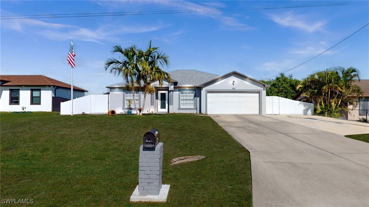 2602 5th Street Southwest Lehigh Acres, FL 33976 - Photo 1 of 17 a front view of a house with a yard