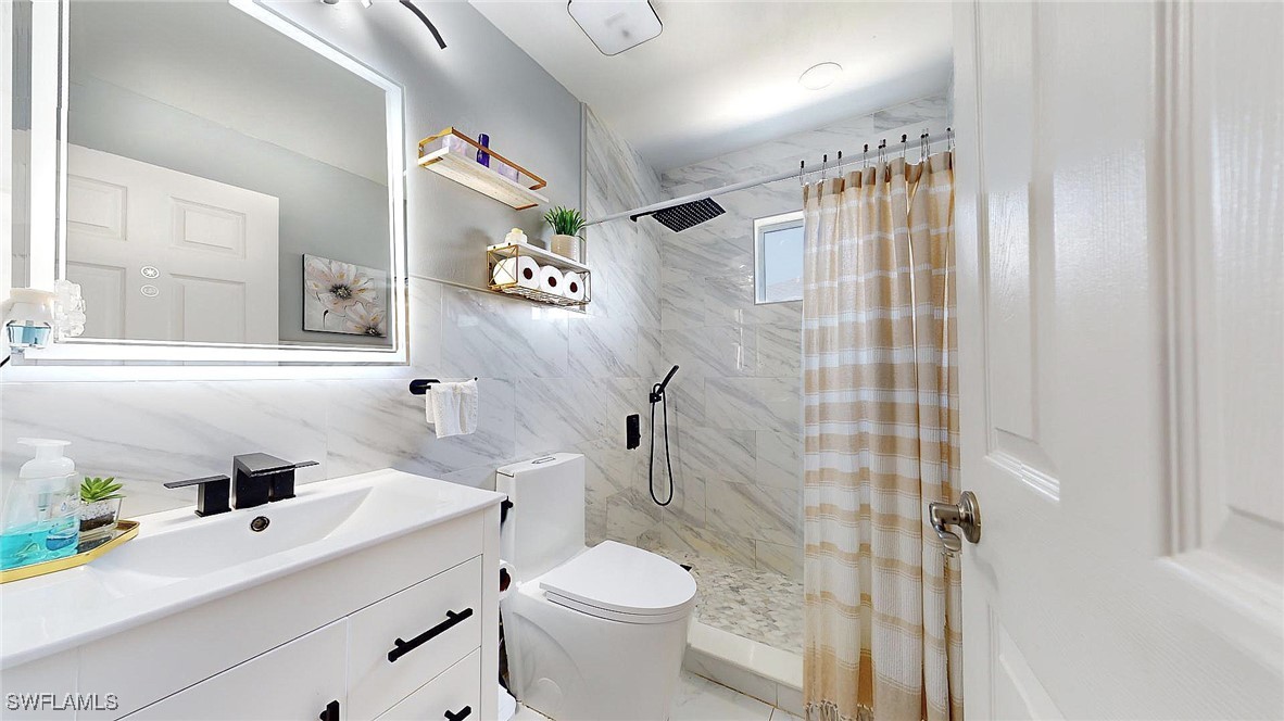2602 5th Street Southwest Lehigh Acres, FL 33976 - Photo 14 of 17 a bathroom with a sink toilet and shower