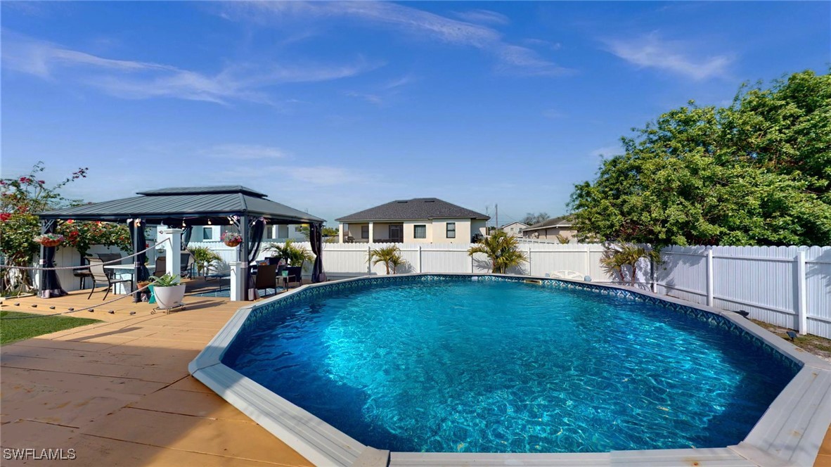 2602 5th Street Southwest Lehigh Acres, FL 33976 - Photo 6 of 17 a swimming pool with outdoor seating and yard