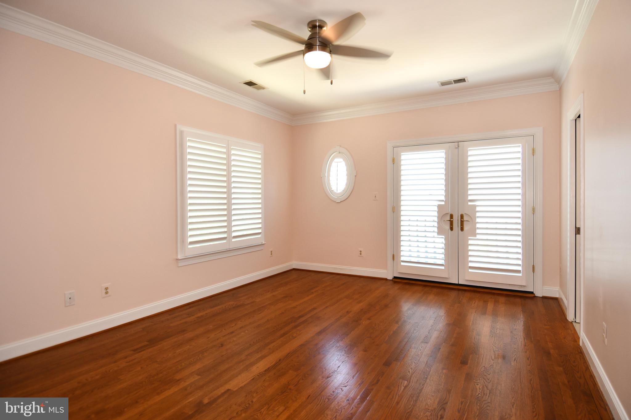 7808 Southdown Road Alexandria, VA 22308 - Photo 81 of 99 a view of an empty room with wooden floor and a window