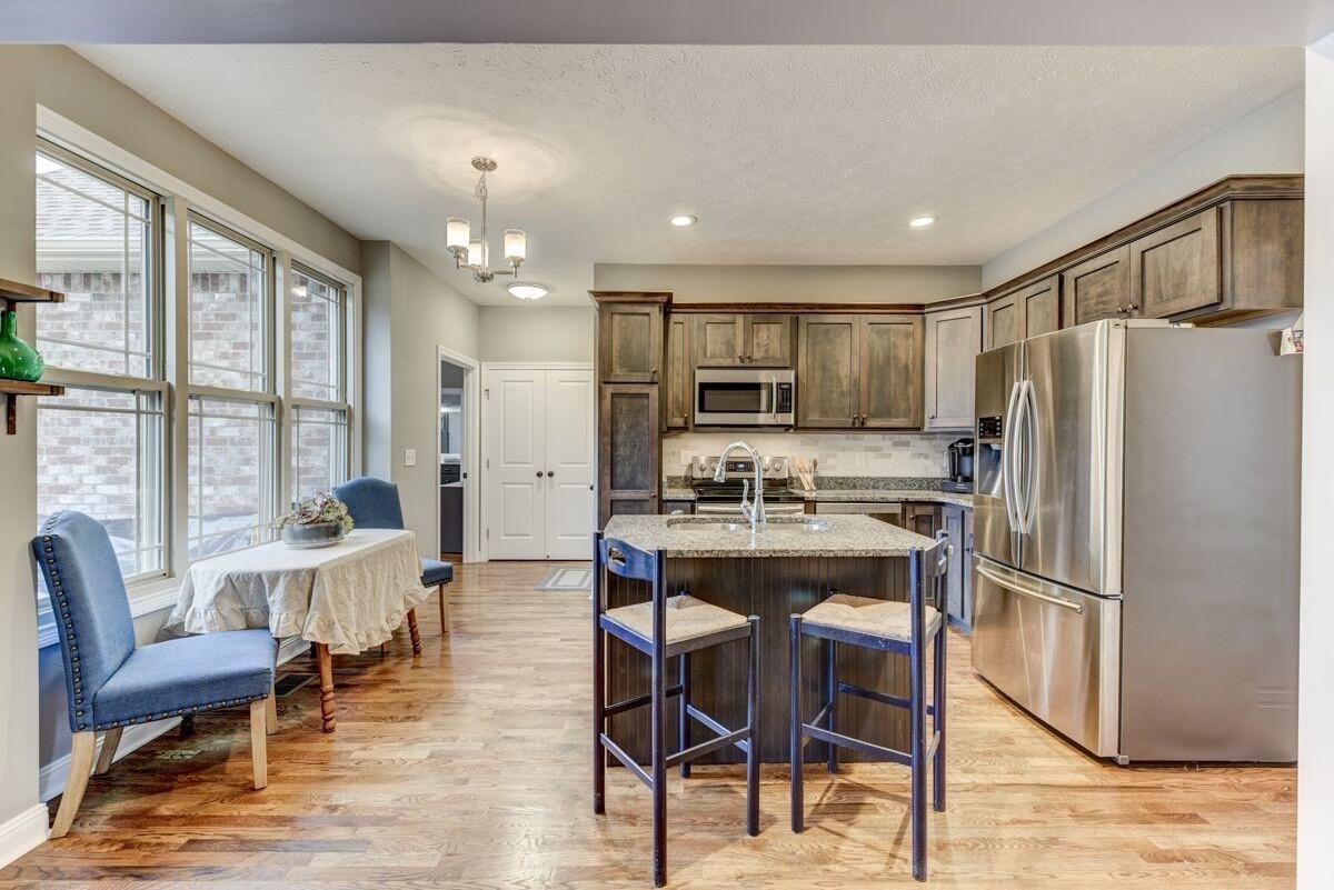 439 Tom Link Road Cottontown, TN 37048 - Photo 7 of 20 a kitchen with refrigerator a table and chairs