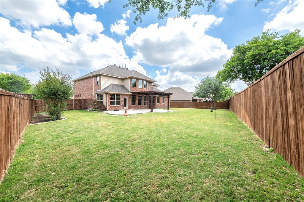 12571 Valley Spring Drive Frisco, TX 75035 - Photo 38 of 39 a view of a house with backyard and garden