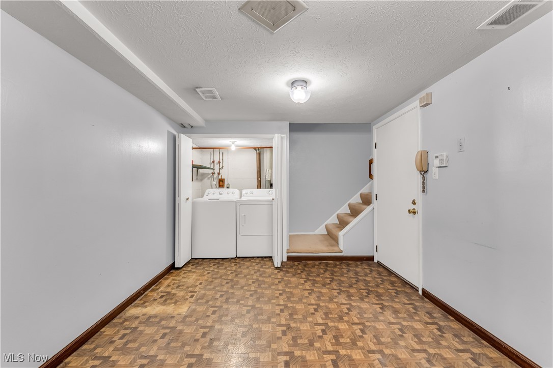 6470 State Road, Unit K5 Parma, OH 44134 - Photo 23 of 26 Laundry room featuring a textured ceiling and washing machine and clothes dryer