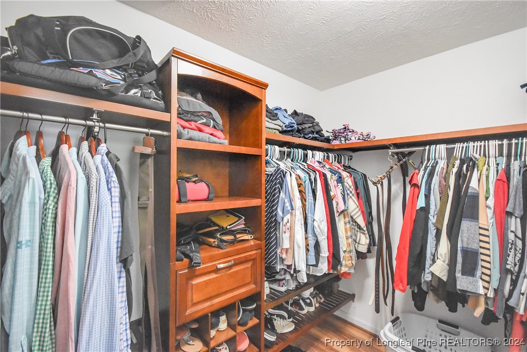 184 Chesapeake Road Cameron, NC 28326 - Photo 26 of 50 a view of walk in closet with clothes