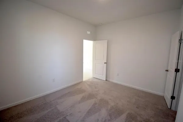 a view of an empty room and a window