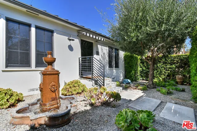 a front view of a house with outdoor seating
