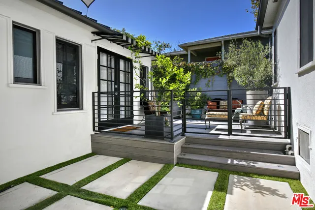 a view of two chairs in the patio